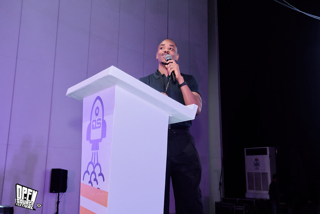 Druids speaking at a podium at Open Source Festival